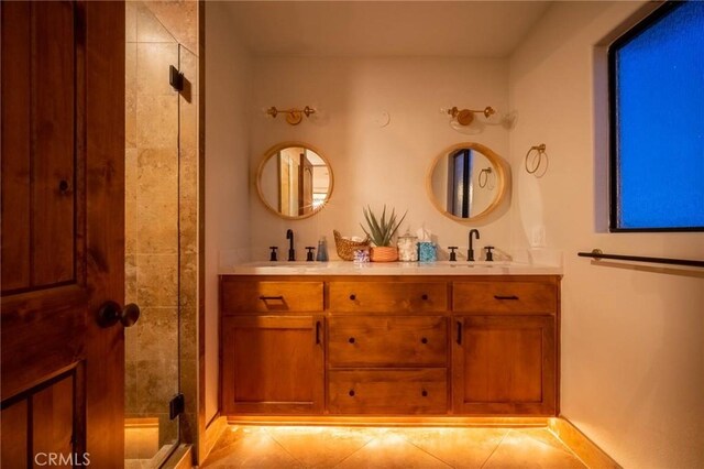 bathroom featuring tile patterned floors, walk in shower, and vanity