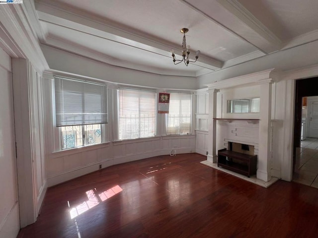 unfurnished living room featuring crown molding, beam ceiling, dark hardwood / wood-style floors, and a notable chandelier