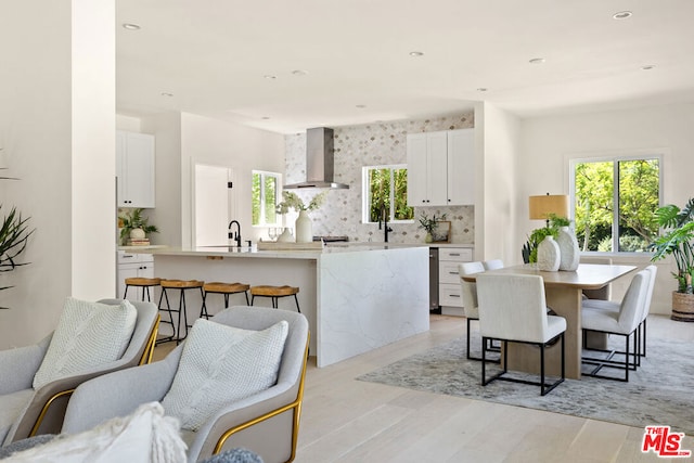 dining room with light hardwood / wood-style floors and sink