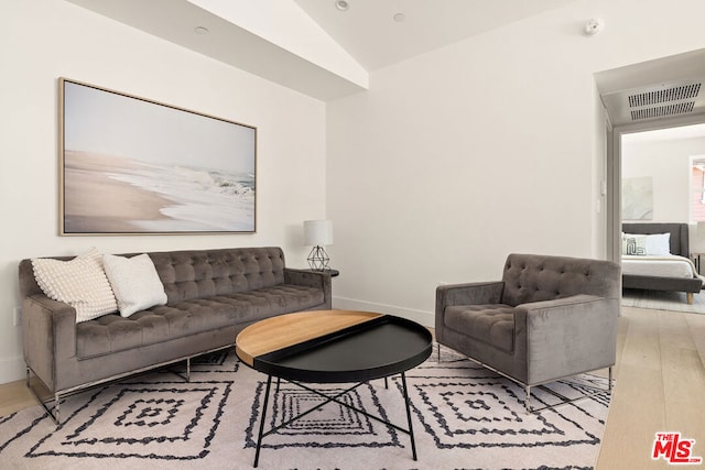 living room featuring light hardwood / wood-style floors and lofted ceiling