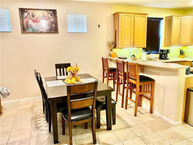 dining space featuring a wealth of natural light and light tile patterned floors