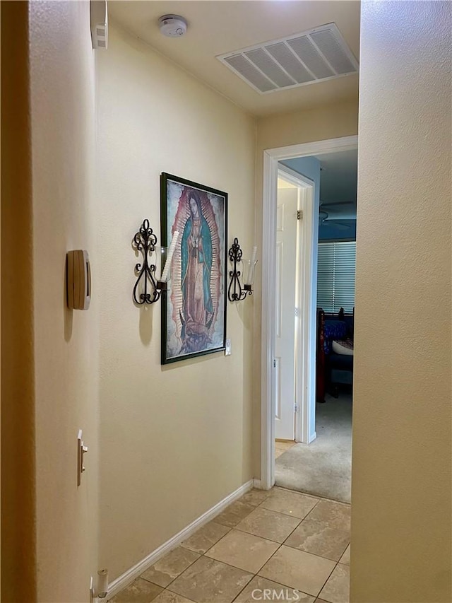 hallway featuring light tile patterned floors