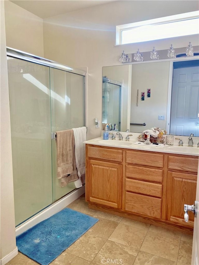 bathroom featuring vanity and a shower with shower door