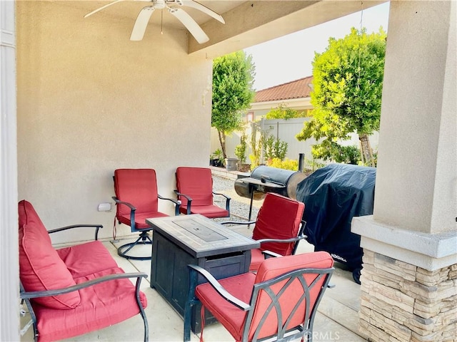 view of patio / terrace with ceiling fan and a fire pit