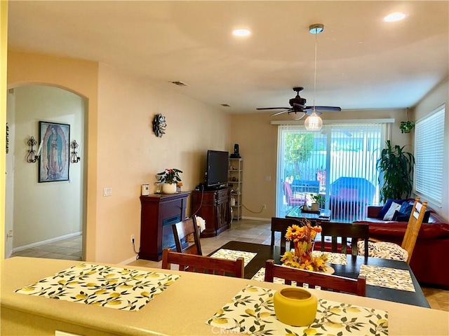 dining space with light tile patterned floors and ceiling fan