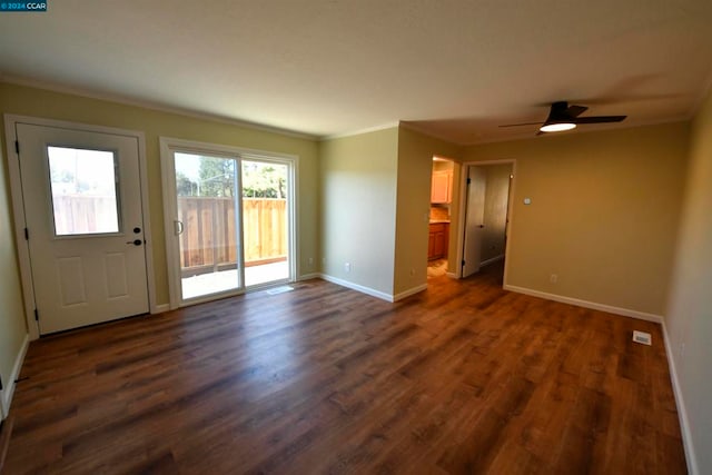 foyer featuring ceiling fan, ornamental molding, and dark hardwood / wood-style flooring