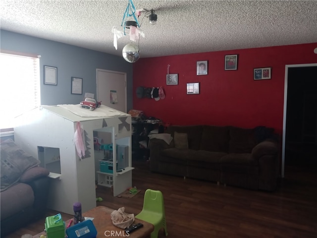 living room with wood-type flooring and a textured ceiling