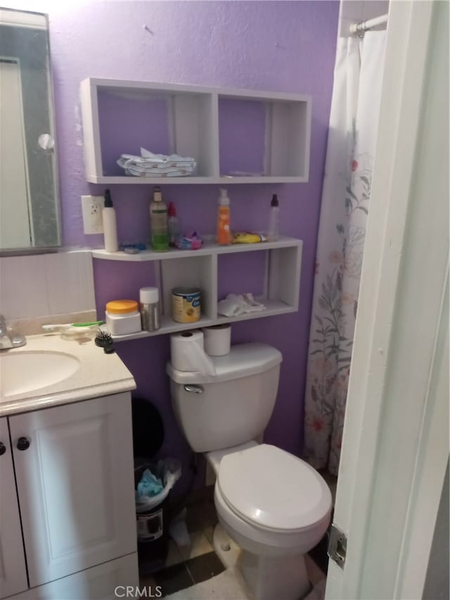 bathroom with vanity, toilet, and a shower with shower curtain