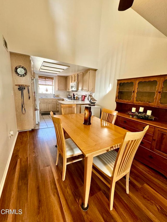 dining room featuring lofted ceiling and hardwood / wood-style floors