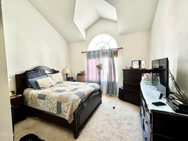 bedroom featuring light carpet and lofted ceiling