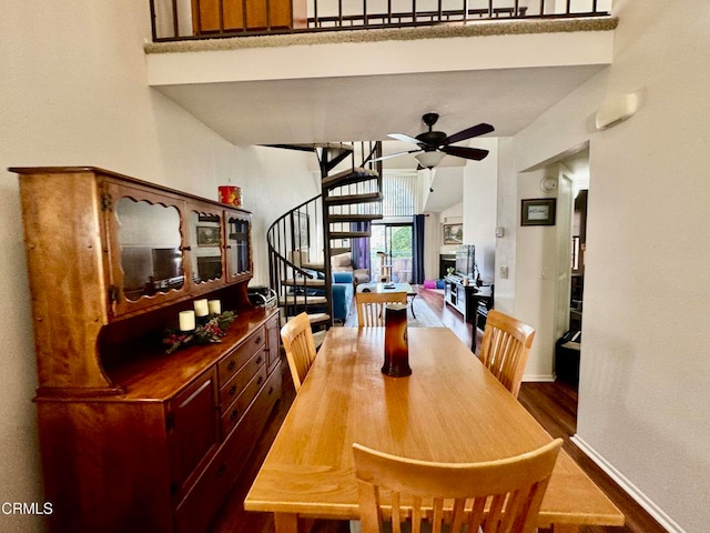 dining space with hardwood / wood-style floors and ceiling fan