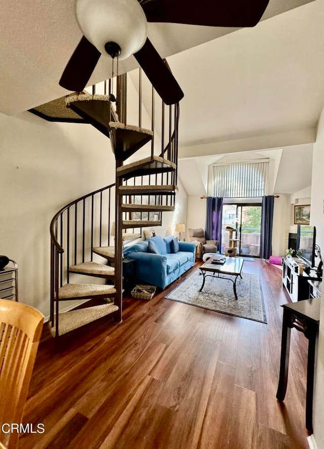 living room with wood-type flooring, lofted ceiling, and ceiling fan