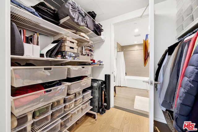 walk in closet featuring hardwood / wood-style floors