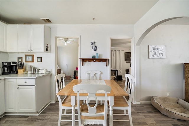 dining space featuring ceiling fan and dark wood-type flooring