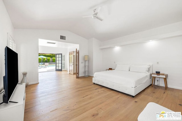 bedroom featuring ceiling fan, light hardwood / wood-style floors, and vaulted ceiling