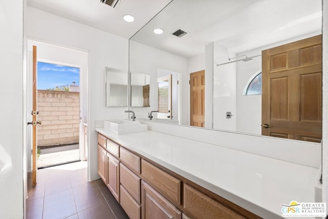 bathroom with tile patterned flooring and vanity