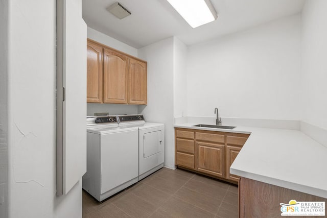 laundry room with separate washer and dryer, sink, and cabinets