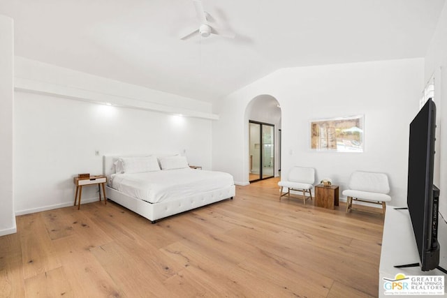 bedroom featuring ceiling fan, light hardwood / wood-style floors, and vaulted ceiling