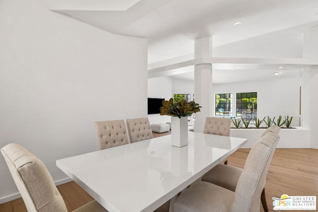 dining area featuring light hardwood / wood-style floors and lofted ceiling