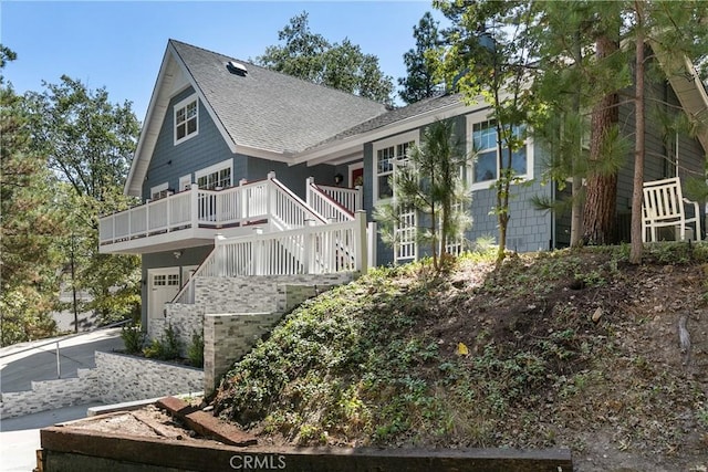 28281 Arbon Ln, Lake Arrowhead, CA 92352 - view of front facade featuring a shingled roof, a garage, and a deck