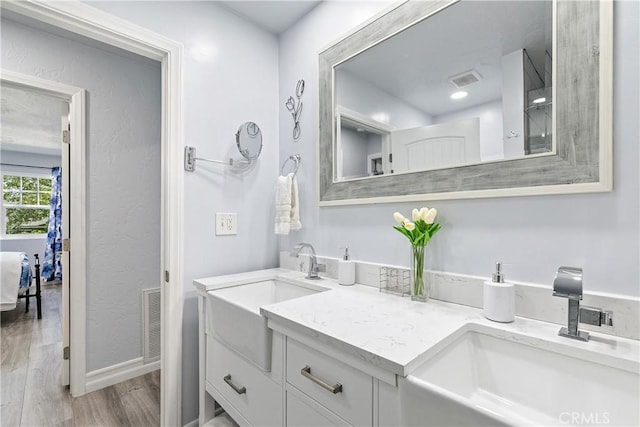 28281 Arbon Ln, Lake Arrowhead, CA 92352 - bathroom with wood finished floors, double vanity, and baseboards