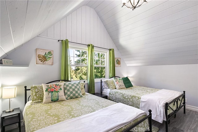 bedroom featuring lofted ceiling and dark hardwood / wood-style flooring