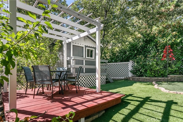 wooden terrace featuring a lawn and a pergola