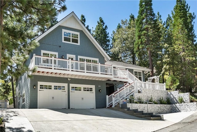 28281 Arbon Ln, Lake Arrowhead, CA 92352 - view of front of property with a garage, concrete driveway, a deck, and stairway