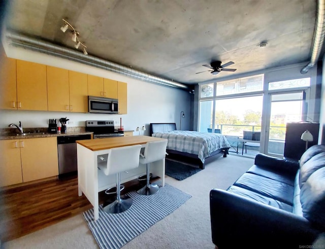 bedroom with hardwood / wood-style floors and sink