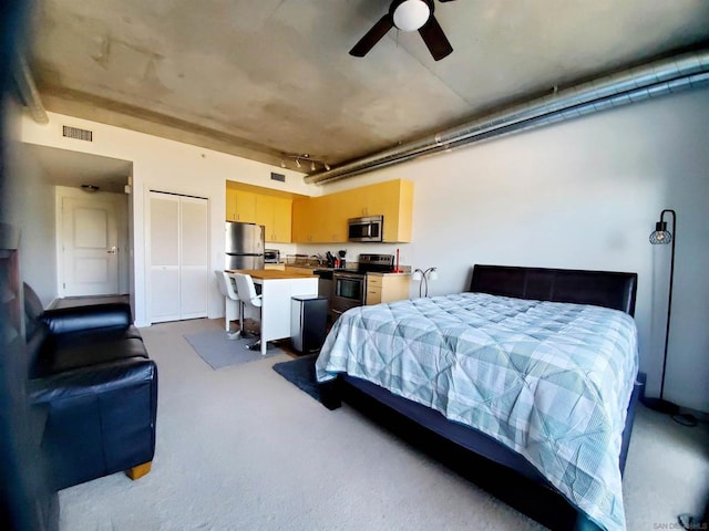 bedroom featuring ceiling fan, a closet, and stainless steel fridge