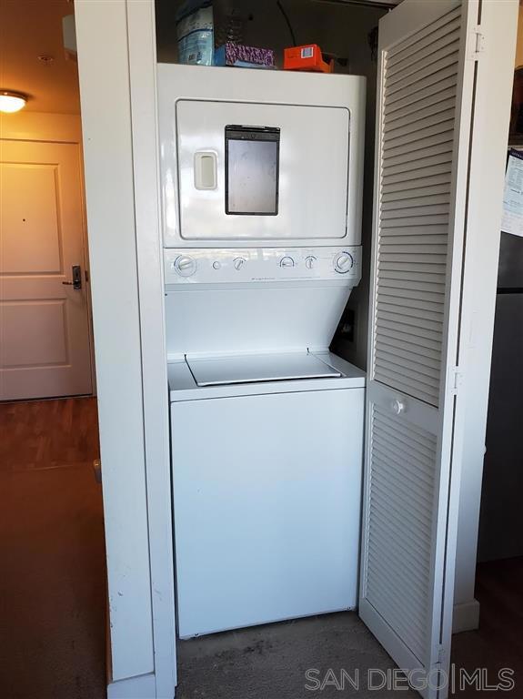 laundry room featuring stacked washer / dryer