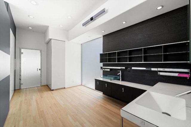 kitchen with light wood-type flooring and sink