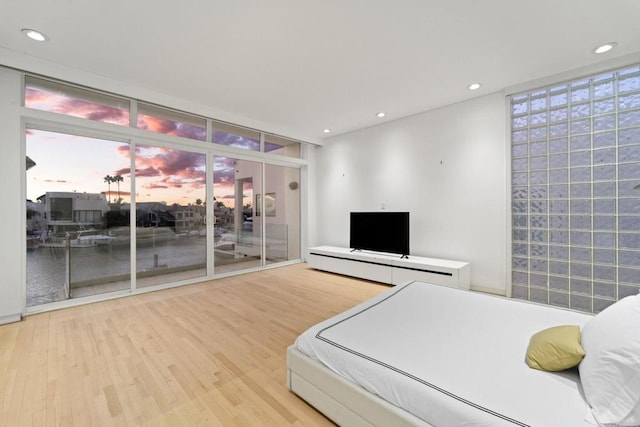 bedroom featuring access to exterior and wood-type flooring