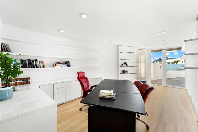 office area with light hardwood / wood-style flooring and floor to ceiling windows