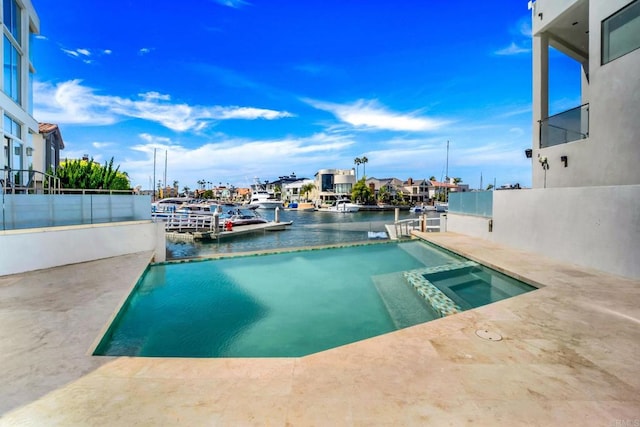 view of pool featuring an in ground hot tub and a water view