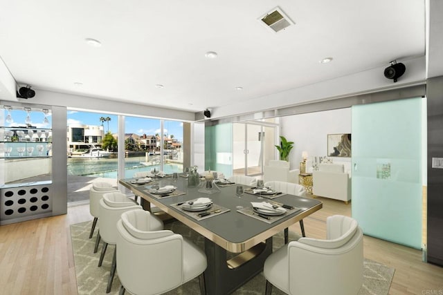 dining space featuring light wood-type flooring