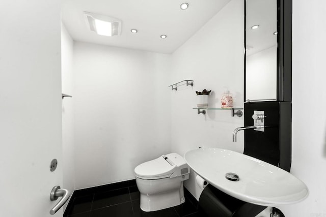 bathroom with tile patterned flooring, toilet, and sink