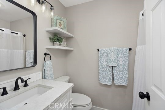 bathroom featuring toilet and vanity