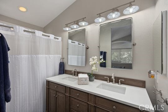 bathroom with vanity and vaulted ceiling