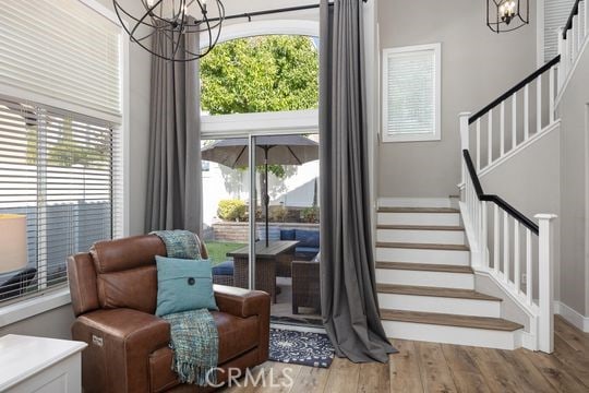 sitting room with a chandelier and light hardwood / wood-style floors