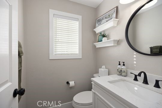 bathroom featuring toilet and vanity