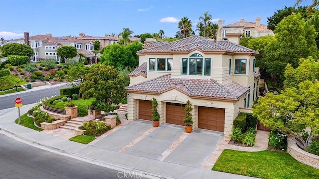 mediterranean / spanish home featuring a garage