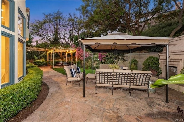 patio terrace at dusk with a gazebo and an outdoor living space