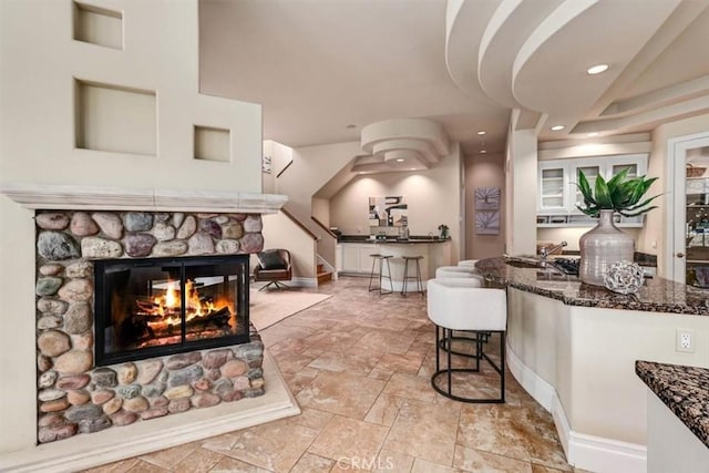 living room with a stone fireplace