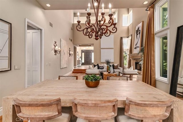 dining room with a towering ceiling and an inviting chandelier