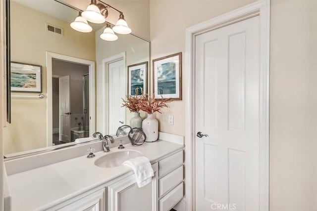 bathroom with vanity and a notable chandelier