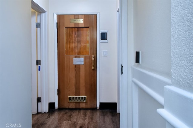 hallway with dark wood-type flooring