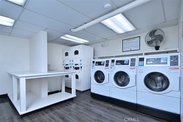 washroom featuring separate washer and dryer, stacked washing maching and dryer, and dark hardwood / wood-style flooring