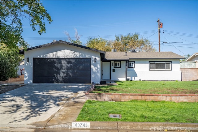 single story home with a garage and a front lawn