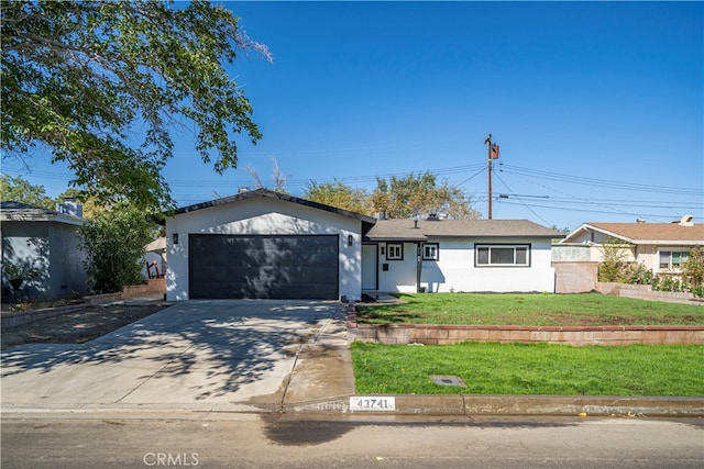 ranch-style house with a garage and a front lawn